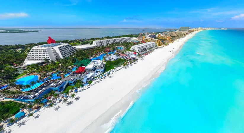 Grand Oasis Cancun — aerial view of pyramid tower, pools, and Caribbean beach