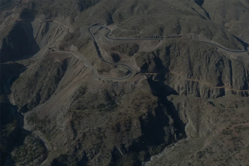 Paolini Hnos. road construction — motor grader and paving crew on a highway project