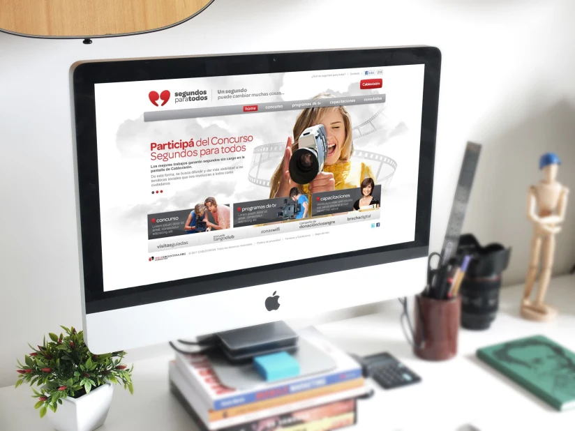 Segundos para Todos campaign homepage displayed on an iMac — contest hero and program modules